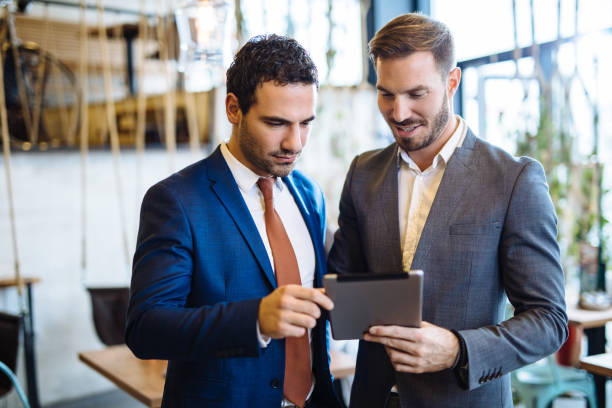 istock Two young businessmen discussing business strategy using digital tablet 1125884332