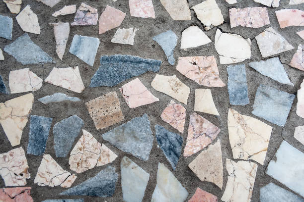 istock Concrete surface with multiple patches of large colored stones 1125885717