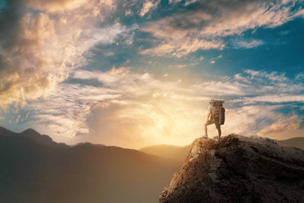 istock Hiker with backpack standing on top of a mountain and enjoying. 1125885924