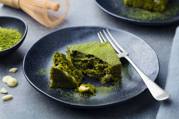 istock Matcha green tea cake, bars, brownie with white chocolate on a plate. Grey background. 1125886963