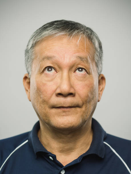 istock Real chinese senior man with blank expression looking up 1125887248