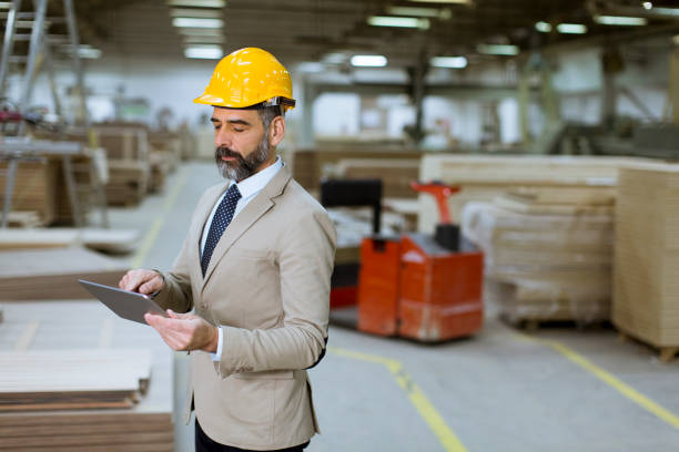 istock Middle-aged businessman with digital tablet in factory 1125888659