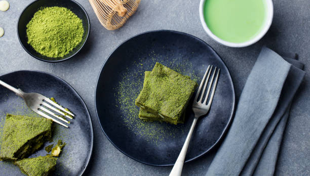 istock Matcha green tea cake, bars, brownie with white chocolate on a plate. Grey background. Top view. 1125889059