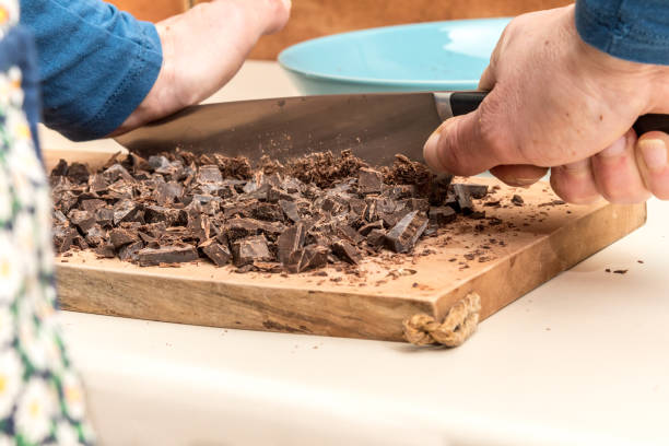 istock Woman Hands Chopping Chocolate Block for Making Cookies 1125891127