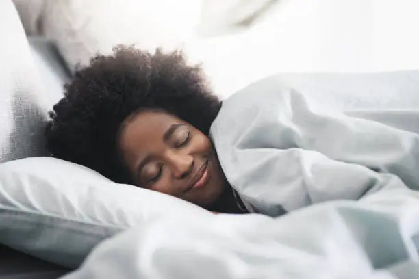 Shot of an attractive young woman sleeping in her bed in the morning at home