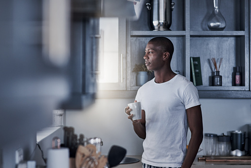 Shot of a young man having coffee during a relaxing morning at home