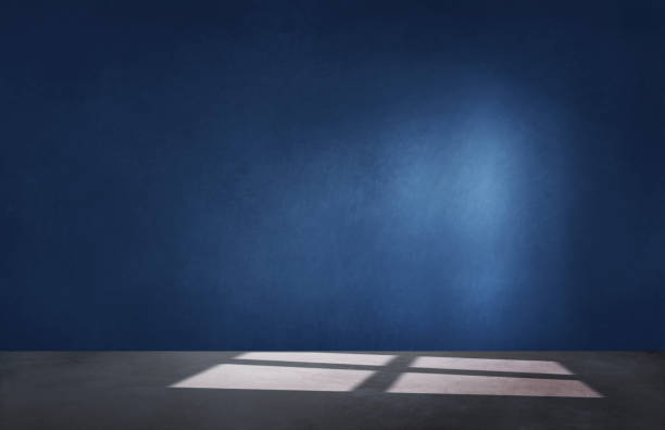 istock Dark blue wall in an empty room with a concrete floor 1125893375