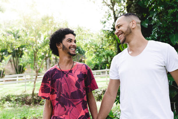istock LGBT couple walking in the public park 1125896351