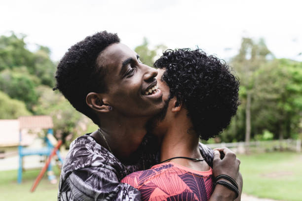 istock Friends hugging at public park 1125896441