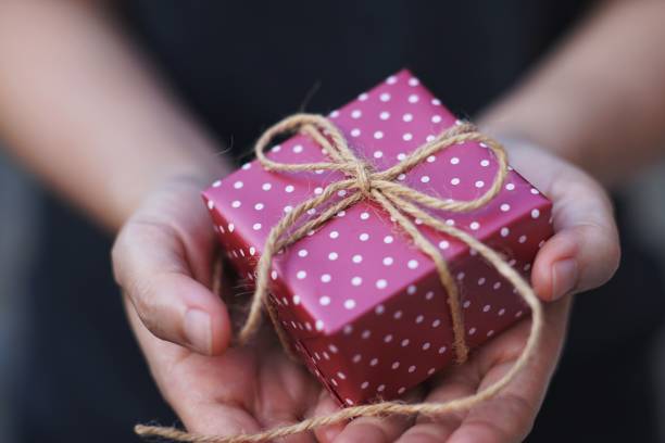 istock Lovely red gift box in hand, sweet valentine present giving concept, copy space 1125897106