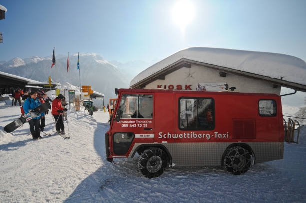 Braunwald in Winter Braunwald a small Village in the Swiss Alps during Winter Season with some electric transport vehicles and people going for siikng. switzerland european alps ski winter stock pictures, royalty-free photos & images