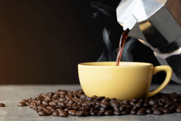 istock Coffee pouring to cup with coffee bean on black background 1125898754