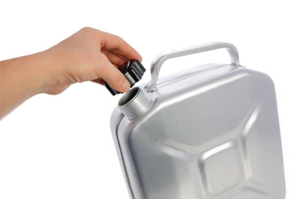 istock A man's hand opens a metal can for gasoline, isolated on a white background. 1125900660