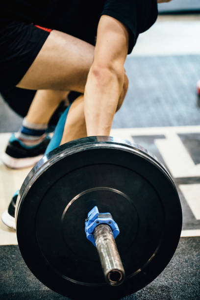 istock Low Section Of Man Holding Barbell In Gym 1125900698