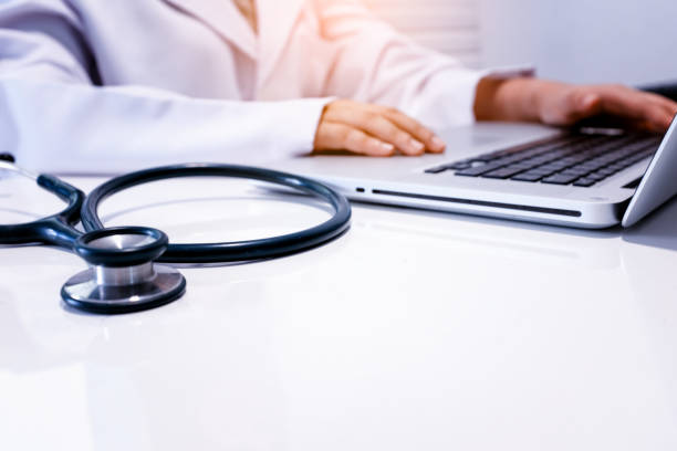 istock Midsection Of Doctor Using Laptop With Stethoscope On Table 1125900760