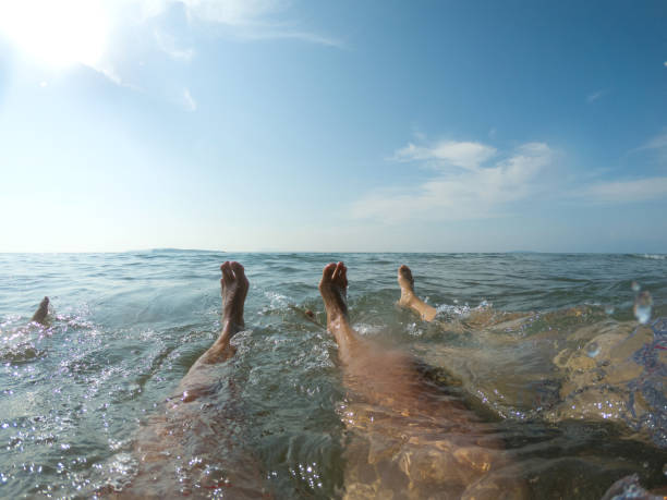 istock Feet in sea water 1125901738