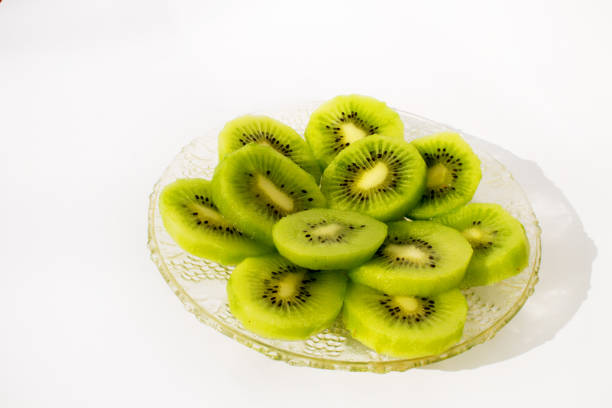 istock kiwi fruit glassy plate with shadow on the white background 1125902141