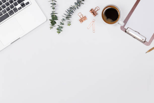 istock Woman home office desk workspace with laptop, eucalyptus leaf, notebook and coffee cup on white background. Flat lay, Top view. Stylish female concept. Image. 1125903245