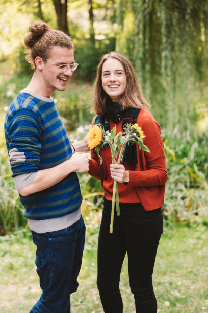 istock friends with flowers having a good time on picnic 1125903704