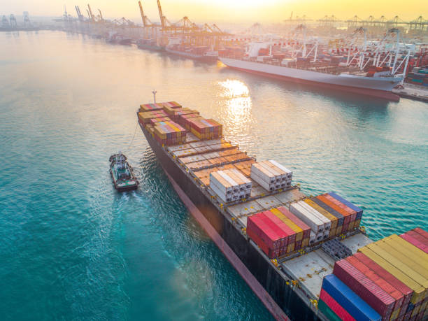 working in port terminal aerial view of containers ship vessel arrival approach to the main entrance gate od an international port, transport and logistics system services to worldwide global of seas and lands moored photos stock pictures, royalty-free photos & images