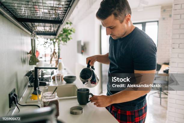 Preparing First Cup Of Coffee In The Morning Stock Photo - Download Image Now - Kitchen, Morning, Pouring