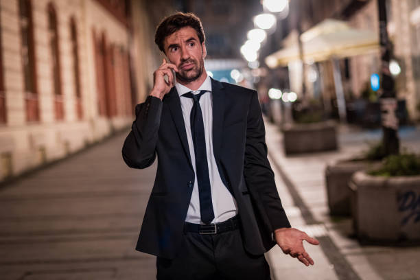 istock man in suit talking on the phone 1125906423