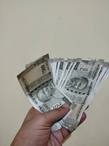 istock Hand holding new Indian currency 1125908628