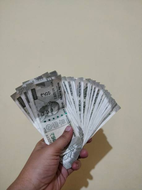 istock Hand holding new Indian currency 1125908658