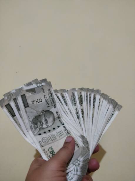 istock Hand holding new Indian currency 1125908676