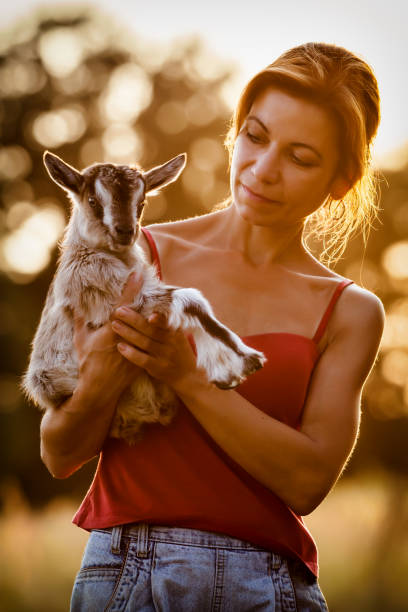 istock Woman and small goatling portrait 1125908720