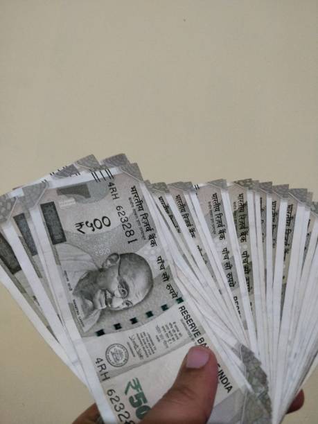 istock Hand holding new Indian currency 1125908723