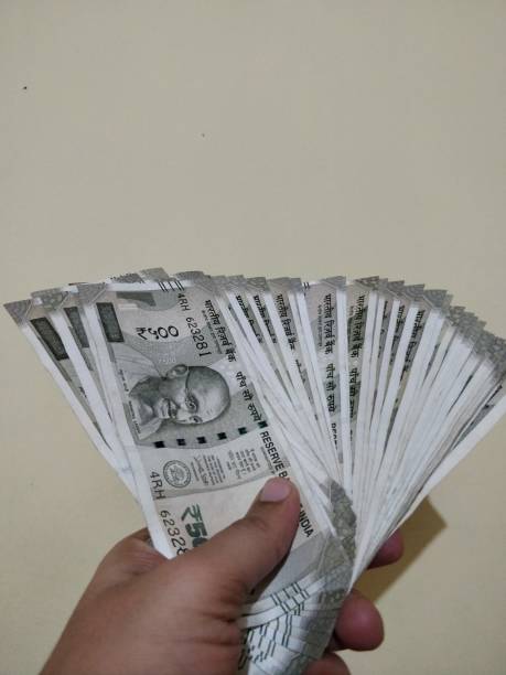 istock Hand holding new Indian currency 1125908790