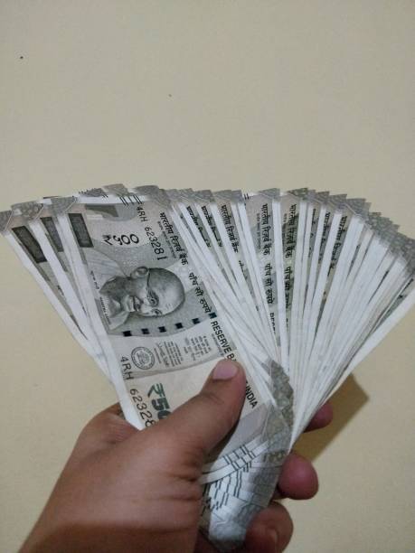 istock Hand holding new Indian currency 1125908869