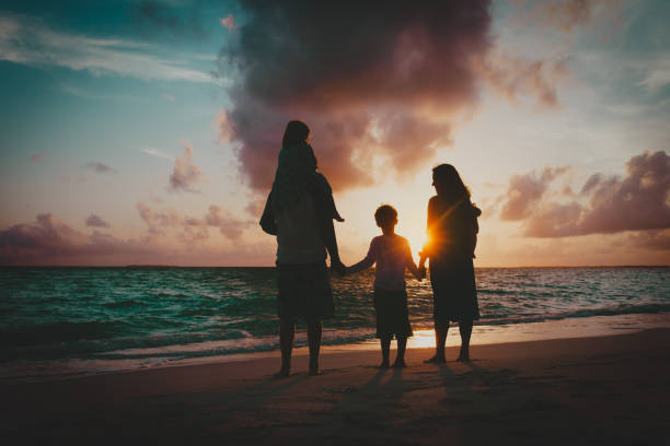 istock happy family with kids having fun at sunset beach 1125909982