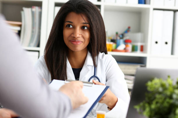 istock Female doctor hand hold silver pen and showing 1125910194