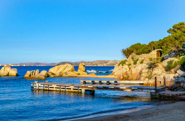 PALAU, OLBIA-TEMPIO, SARDINIA, ITALY, September 3, 2018: View of a cove with a small pier at sunset, in a village called Porto Rafael.