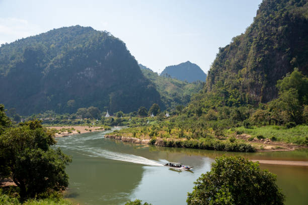 istock Mountain landscape view with river boat and white pagodas 1125911571
