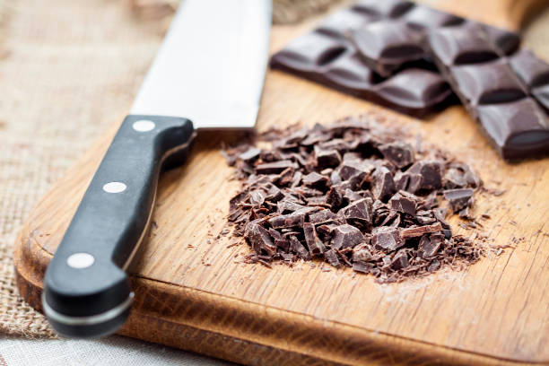 istock Chopped dark chocolate on wooden cutting board 1125912578