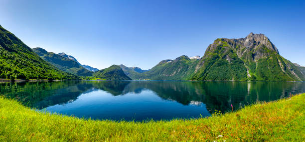 fjord - mountain peak norway reflection sunlight stock-fotos und bilder