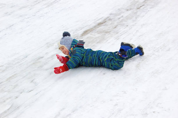 istock A four-year-old child, a boy, rides his stomach from a hill 1125913767
