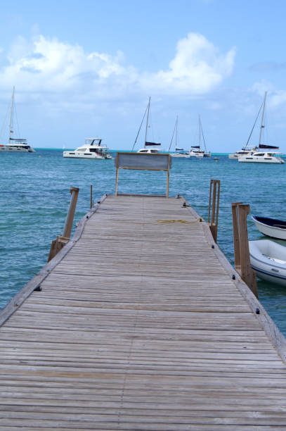 istock Pier Dock with Sailboats and Dingy with Message Sign 1125914202