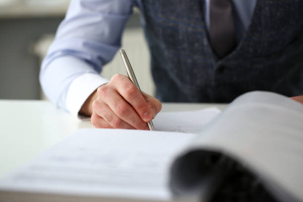 istock Clerk man at office workplace with silver pen in arms 1125914282
