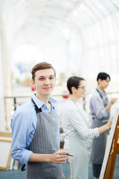 istock Smiling Boy Painting in Art Studio 1125914608