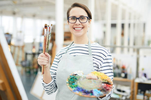 istock Smiling Female Artist Holding Palette 1125914660