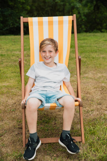 istock Young Boy Relaxing on a Deck Chair 1125914739
