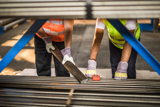 istock Unrecognizable manual workers working with iron in aluminum mill. 1125915361