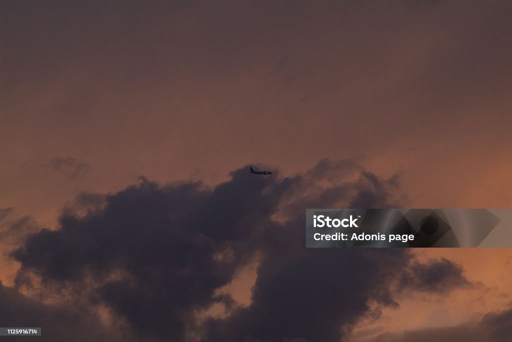 Auburn nights, sky captain Commercial airliners aviate highways of the sky on a summers eve auburn cloudscape Airplane Stock Photo