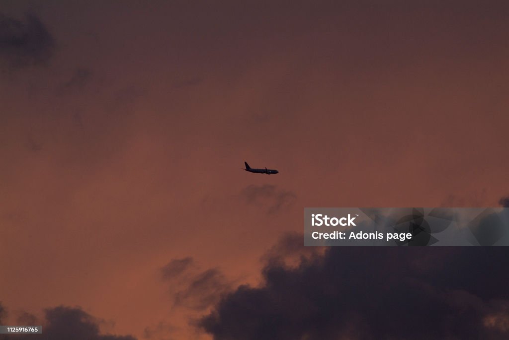 Auburn nights, sky captain Commercial airliners aviate highways of the sky on a summers eve auburn cloudscape Airplane Stock Photo