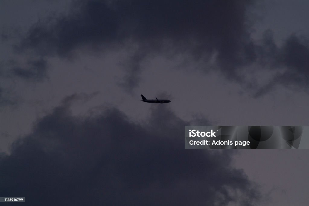 Auburn nights, sky captain Commercial airliners aviate highways of the sky on a summers eve auburn cloudscape Airplane Stock Photo