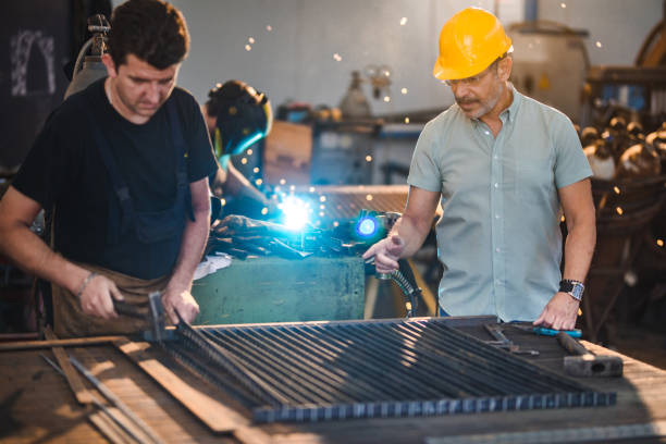 istock Quality control inspector supervising metal worker in aluminum mill. 1125917015